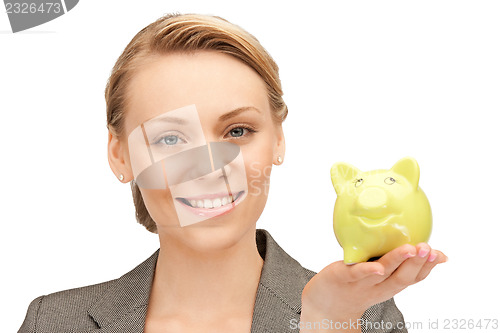 Image of lovely woman with piggy bank