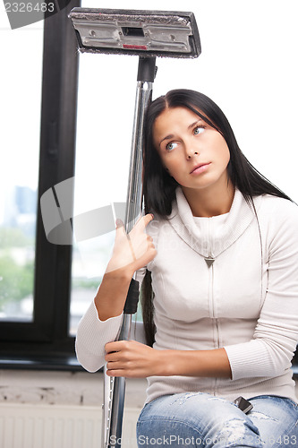 Image of lovely housewife with vacuum cleaner