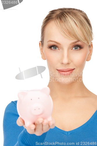 Image of lovely woman with piggy bank