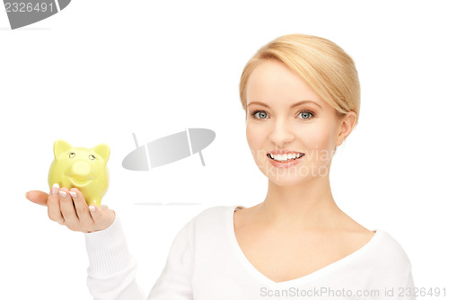 Image of lovely woman with piggy bank