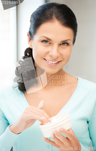 Image of beautiful woman with moisturizing creme