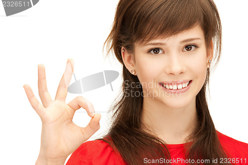 Image of lovely teenage girl showing ok sign