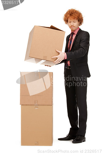 Image of attractive businessman with big boxes