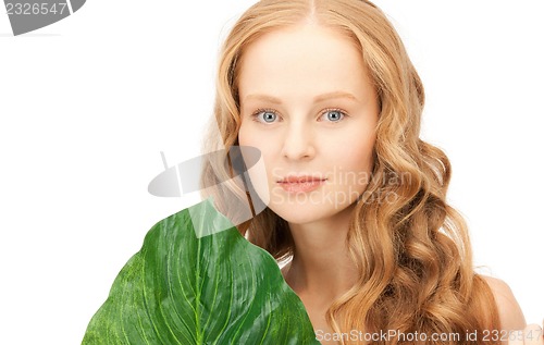 Image of woman with green leaf