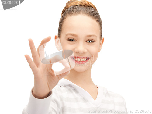 Image of lovely teenage girl showing ok sign