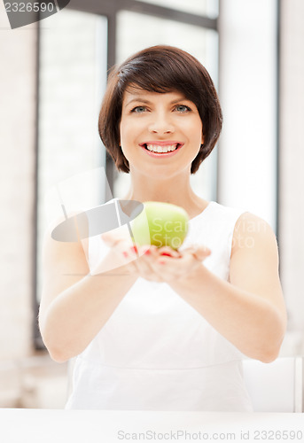Image of lovely housewife with green apple