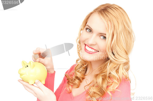 Image of lovely woman with piggy bank and money