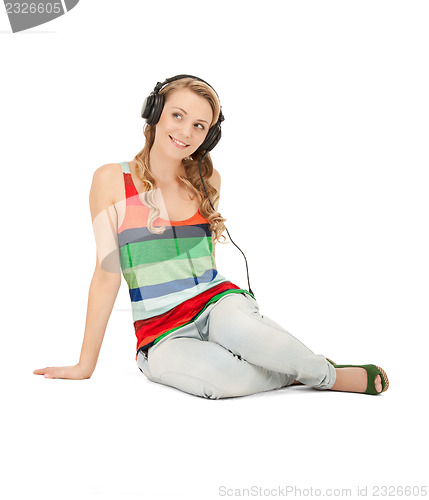 Image of happy teenage girl in big headphones