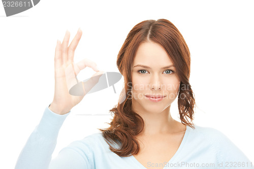 Image of lovely teenage girl showing ok sign