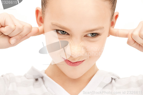 Image of teenage girl with fingers in ears