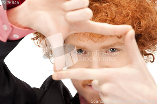 Image of handsome man creating a frame with fingers