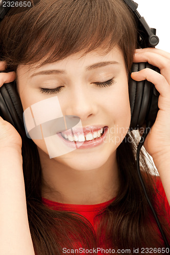 Image of happy teenage girl in big headphones