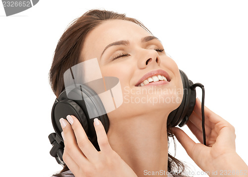 Image of happy teenage girl in big headphones
