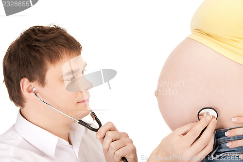 Image of doctor and pregnant woman belly