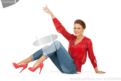 Image of lovely woman in red blouse and jeans