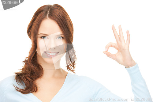 Image of lovely teenage girl showing ok sign