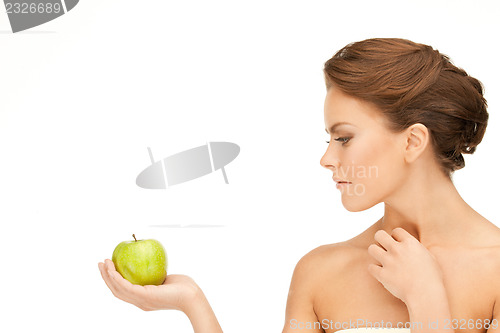 Image of young beautiful woman with green apple