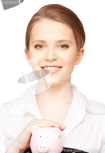 Image of lovely woman with piggy bank