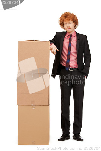 Image of attractive businessman with big boxes