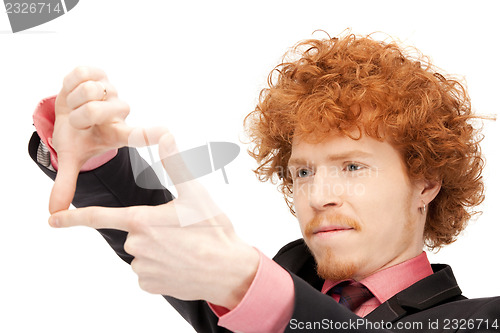 Image of handsome man creating a frame with fingers