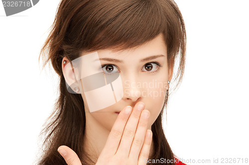 Image of teenage girl with palms over mouth