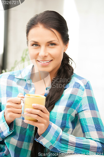 Image of lovely housewife with mug