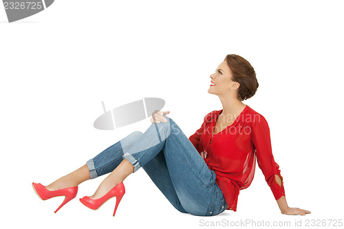 Image of lovely woman in red blouse and jeans