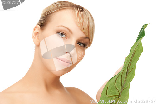 Image of woman with green leaf