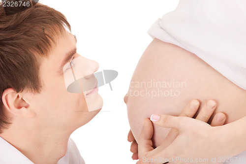 Image of male face and pregnant woman belly