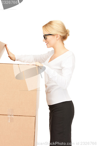 Image of attractive businesswoman with big boxes