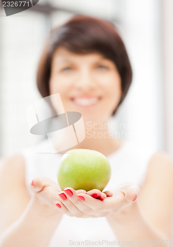 Image of lovely housewife with green apple