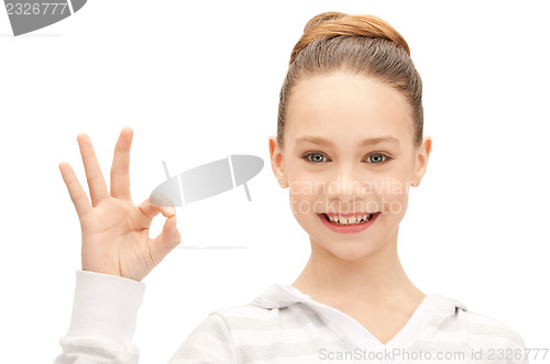 Image of lovely teenage girl showing ok sign