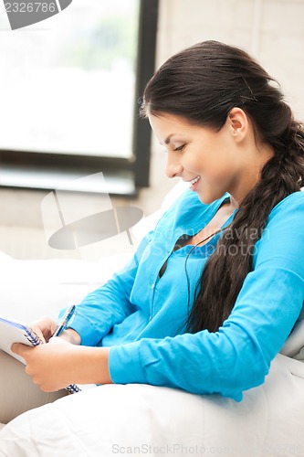 Image of happy woman with big notepad