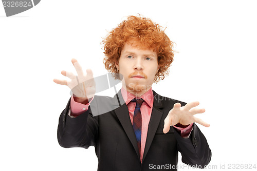 Image of businessman working with something imaginary