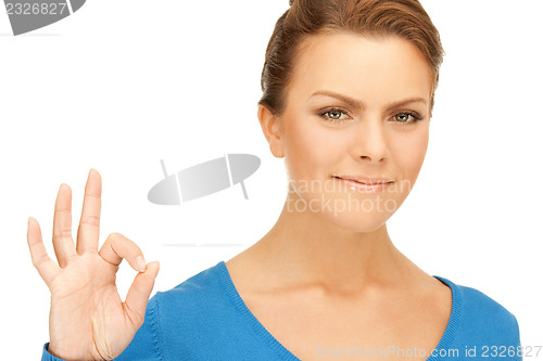 Image of lovely teenage girl showing ok sign