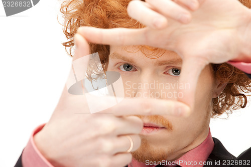 Image of handsome man creating a frame with fingers