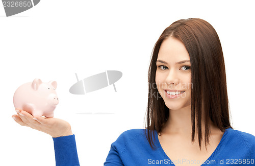 Image of lovely woman with piggy bank