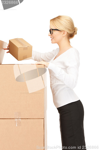 Image of attractive businesswoman with big boxes