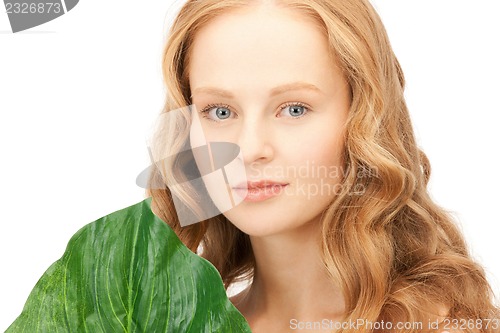 Image of woman with green leaf