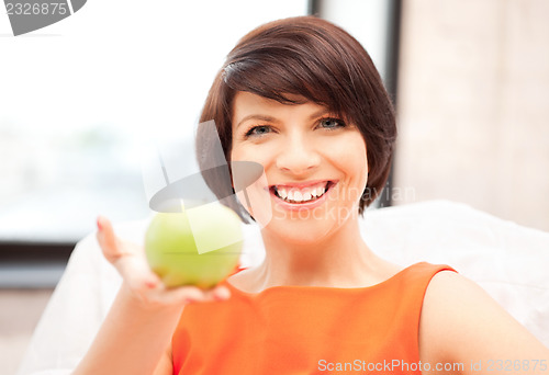 Image of lovely housewife with green apple