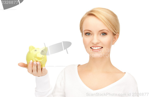 Image of lovely woman with piggy bank