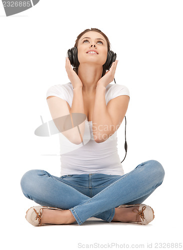 Image of happy teenage girl in big headphones