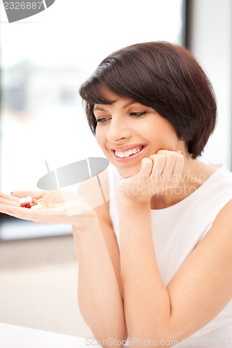 Image of young beautiful woman with pills