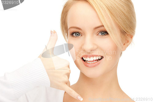 Image of woman making a call me gesture