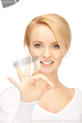 Image of lovely teenage girl showing ok sign