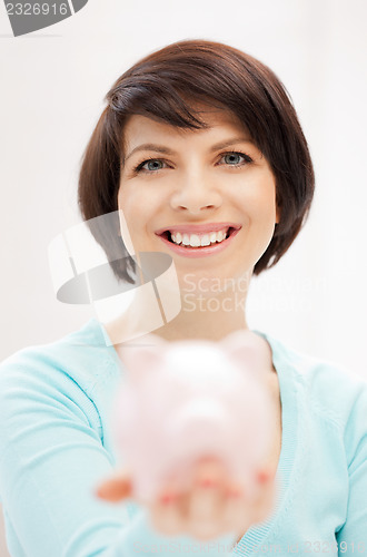 Image of lovely woman with piggy bank