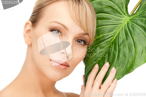 Image of woman with green leaf