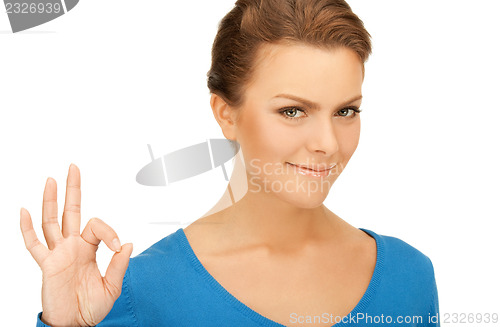 Image of lovely teenage girl showing ok sign