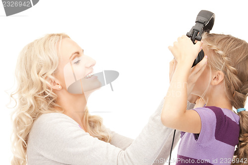 Image of mother and little girl with headphones