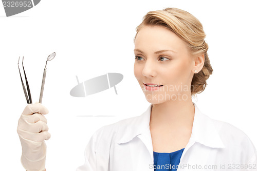 Image of dentist with tools